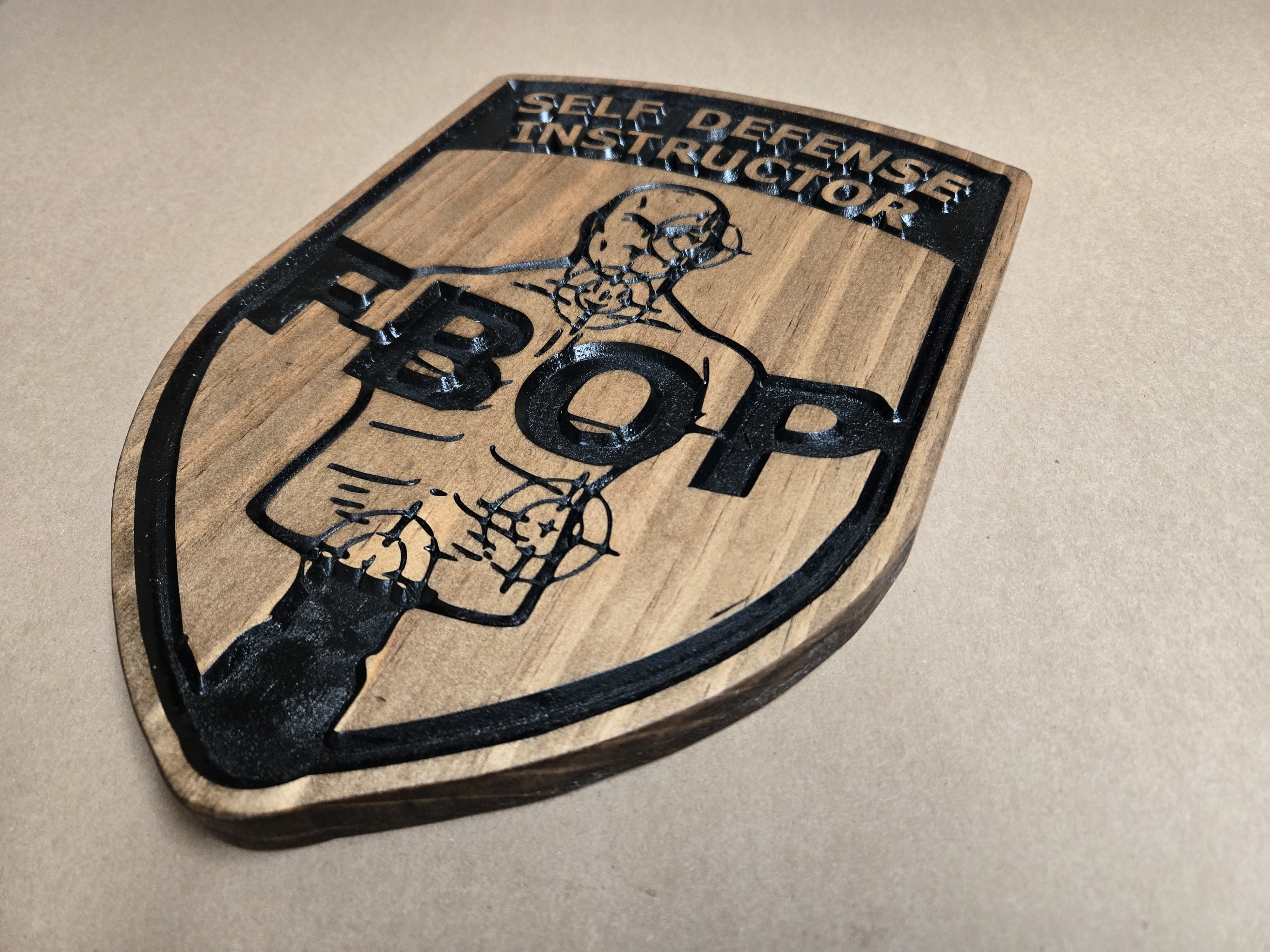Looking for a meaningful, high-quality gift for a Federal Bureau of Prisons officer, Disturbance Control Team (DCT) member, Special Operations Response Team (SORT) operator, or self-defense instructor? A custom wooden Federal Bureau of Prisons emblem plaque delivers lasting recognition that mass-produced items simply can’t match. These handcrafted pine wood signs from Custom Wood Design combine official-looking detail with personal customization options, making them ideal retirement gifts, promotion awards, team send-offs, or office décor for current staff. Why Choose a Custom Wood BOP Emblem Plaque? Federal Bureau of Prisons personnel work in high-stakes environments. Whether serving on a Special Operations Response Team, Disturbance Control Team, or as a self-defense instructor, their dedication deserves more than a generic certificate or plastic award. A solid wood plaque offers: Premium craftsmanship with a professional appearance Durable indoor finish that holds up over years Full personalization for institution names, ranks, team designations, or individual titles A tangible keepsake that looks impressive on a wall or shelf Popular designs include the classic Federal Bureau of Prisons seal, SORT emblems featuring the eagle and motto “Fortuna Favet Fortibus,” and specialized versions such as Self Defense Instructor or DCT plaques. Product Highlights: Federal Prison Emblem – DCT Sign One standout option is the Federal Prison Emblem – DCT – Federal Bureau of Prisons sign (SKU CWD-729). Key specifications: Dimensions: 13.5" wide × 11" high × ¾" thick Material: Solid pine wood Finish: Dark walnut front with indoor polyurethane sealer Hardware: Two sawtooth hangers installed Price: $50 with free U.S. shipping Customization: Change the top text to any institution name or officer title Customers consistently praise the detail and quality. Reviews note the plaques arrive surprisingly fast for the level of craftsmanship and that teams reorder them regularly for departing members. Similar custom options exist for broader Federal Bureau of Prisons signs and fully personalized emblems. Perfect Occasions for a BOP Wooden Plaque These plaques work especially well for: Retirement or transfer gifts Recognition of SORT or DCT service Self-defense instructor certifications or milestones Team awards and unit pride displays Holiday or appreciation gifts for correctional staff Because the text and artwork can be adjusted, one base design serves multiple needs—simply request the specific title, institution, or team name. How Customization Works Custom Wood Design specializes in made-to-order wooden signs and plaques. You can typically modify: Top banner text (institution, rank, or title) Central emblem details Optional back carving for a personal message Lead times are listed on the product page, and bulk pricing is available for teams ordering multiple plaques. Where to Order Authentic Custom BOP Plaques Shop the Federal Prison Emblem – DCT sign and related Federal Bureau of Prisons plaques directly at Custom Wood Design: Federal Prison Emblem – DCT – Federal Bureau of Prisons sign Explore additional military and government-style wooden signs in their collection for more options. Frequently Asked Questions Are these official BOP plaques? No. These are independently crafted decorative and commemorative plaques designed to honor BOP service. They are not issued by the Federal Bureau of Prisons. Can I personalize the plaque for a specific team or rank? Yes. The top text and other elements can be changed to reflect institutions, SORT, DCT, self-defense instructor titles, or individual names. What material and finish are used? Solid pine wood with a dark walnut finish and indoor polyurethane sealer. Hanging hardware is included and pre-installed. Is shipping free? Yes, free shipping is offered within the U.S. on this product.A well-made custom wooden Federal Bureau of Prisons plaque turns years of service into a display-worthy piece of recognition. Whether for a SORT operator, DCT member, self-defense instructor, or any BOP professional, these signs deliver quality, personalization, and lasting pride. Looking for a meaningful, high-quality gift for a Federal Bureau of Prisons officer, Disturbance Control Team (DCT) member, Special Operations Response Team (SORT) operator, or self-defense instructor? A custom wooden Federal Bureau of Prisons emblem plaque delivers lasting recognition that mass-produced items simply can’t match. These handcrafted pine wood signs from Custom Wood Design combine official-looking detail with personal customization options, making them ideal retirement gifts, promotion awards, team send-offs, or office décor for current staff. Why Choose a Custom Wood BOP Emblem Plaque? Federal Bureau of Prisons personnel work in high-stakes environments. Whether serving on a Special Operations Response Team, Disturbance Control Team, or as a self-defense instructor, their dedication deserves more than a generic certificate or plastic award. A solid wood plaque offers: Premium craftsmanship with a professional appearance Durable indoor finish that holds up over years Full personalization for institution names, ranks, team designations, or individual titles A tangible keepsake that looks impressive on a wall or shelf Popular designs include the classic Federal Bureau of Prisons seal, SORT emblems featuring the eagle and motto “Fortuna Favet Fortibus,” and specialized versions such as Self Defense Instructor or DCT plaques. Product Highlights: Federal Prison Emblem – DCT Sign One standout option is the Federal Prison Emblem – DCT – Federal Bureau of Prisons sign (SKU CWD-729). Key specifications: Dimensions: 13.5" wide × 11" high × ¾" thick Material: Solid pine wood Finish: Dark walnut front with indoor polyurethane sealer Hardware: Two sawtooth hangers installed Price: $50 with free U.S. shipping Customization: Change the top text to any institution name or officer title Customers consistently praise the detail and quality. Reviews note the plaques arrive surprisingly fast for the level of craftsmanship and that teams reorder them regularly for departing members. Similar custom options exist for broader Federal Bureau of Prisons signs and fully personalized emblems. Perfect Occasions for a BOP Wooden Plaque These plaques work especially well for: Retirement or transfer gifts Recognition of SORT or DCT service Self-defense instructor certifications or milestones Team awards and unit pride displays Holiday or appreciation gifts for correctional staff Because the text and artwork can be adjusted, one base design serves multiple needs—simply request the specific title, institution, or team name. How Customization Works Custom Wood Design specializes in made-to-order wooden signs and plaques. You can typically modify: Top banner text (institution, rank, or title) Central emblem details Optional back carving for a personal message Lead times are listed on the product page, and bulk pricing is available for teams ordering multiple plaques. Where to Order Authentic Custom BOP Plaques Shop the Federal Prison Emblem – DCT sign and related Federal Bureau of Prisons plaques directly at Custom Wood Design: Federal Prison Emblem – DCT – Federal Bureau of Prisons sign Explore additional military and government-style wooden signs in their collection for more options. Frequently Asked Questions Are these official BOP plaques? No. These are independently crafted decorative and commemorative plaques designed to honor BOP service. They are not issued by the Federal Bureau of Prisons. Can I personalize the plaque for a specific team or rank? Yes. The top text and other elements can be changed to reflect institutions, SORT, DCT, self-defense instructor titles, or individual names. What material and finish are used? Solid pine wood with a dark walnut finish and indoor polyurethane sealer. Hanging hardware is included and pre-installed. Is shipping free? Yes, free shipping is offered within the U.S. on this product.A well-made custom wooden Federal Bureau of Prisons plaque turns years of service into a display-worthy piece of recognition. Whether for a SORT operator, DCT member, self-defense instructor, or any BOP professional, these signs deliver quality, personalization, and lasting pride.